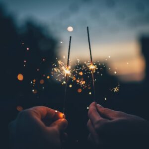 person holding fire cracker shallow focus photography